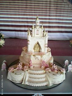 a wedding cake is decorated with pink and gold decorations