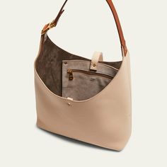 Chloe "Marcie" hobo bag in grained calfskin leather  Shoulder strap  Open top with center leather strap closure  Interior, one zip pocket  Lining: Leather Approx. 8.2"H x 11.4"W x 1.9"D Made in Italy Leather Shoulder Bag With Gold-tone Hardware For On-the-go, Beige Pebbled Leather Shoulder Bag With Gold-tone Hardware, Versatile Leather Hobo Bag With Leather Handles, Versatile Beige Leather Hobo Bag, Leather Hobo Bag With Detachable Strap, Leather Hobo Bag With Detachable Strap In Beige, Beige Leather Hobo Bag With Adjustable Strap, Versatile Leather Hobo Bag With Leather Lining, Double Handle Pebbled Leather Shoulder Bag For On-the-go