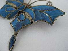 Antique Chinese Kingfisher Butterfly Brooch Dynasty Bird Feather Inlay Blue Vintage Excellent Condition Materials: light gold tone & Kingfisher bird feather Condition: excellent vintage/antique with very light wear Size in inches: H - 1 5/8 W - 2 Maker's mark: none Questions welcome Antique Handmade Blue Brooches, Kingfisher Bird, Bird Feather, Butterfly Brooch, Maker's Mark, Kingfisher, Blue Vintage, Bird Feathers, Makers Mark