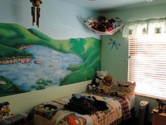 a child's bedroom with a mural on the wall