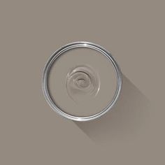 a can of paint with a shadow on the wall