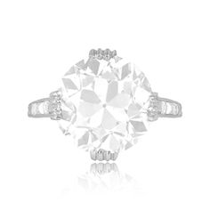 an old cut diamond ring on a white background