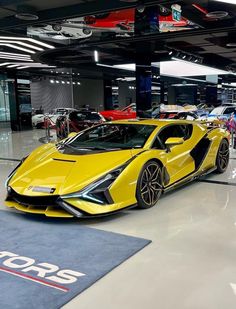 a yellow sports car parked in a showroom