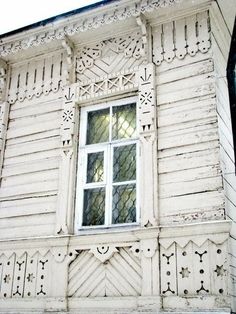 an old white building with a window on the side