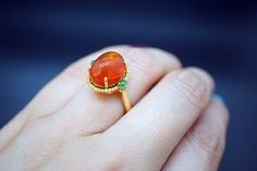 Gem: Mexican Fire Opal 18K gold: 5.2g (Au750 stamped) Opal weight: 6.257ct (stamped) Yellow Diamond: 0.176ct (Genuine) stamped Jadeite: 0.214ct(stamped) Ring size: US6 Treatments: every set stone are natural Color: as shown, can find the sharp sparks of color from different angle Clarity: transparent, precious fire opal Come with Ring box ready for gifting or keepping We look forward to the opportunity of serving you！ Unique Cabochon Ruby Ring For Formal Occasions, Luxury Cabochon Emerald Ring As Gift, Heirloom Style Cabochon Emerald Ring, Luxury Gold Cabochons For Gift, Heirloom Emerald Cabochon Ring As Gift, Yellow Gold Gemstone Cabochons As Gifts, Oval Cabochon Emerald Ring In Yellow Gold, Yellow Gold Round Cabochons For Gifts, Luxury Cabochon Emerald Ring Gift