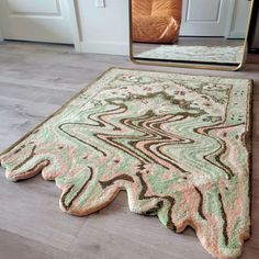 an area rug on the floor in front of a mirror