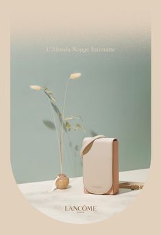 an advertisement for lancome with a vase and plant on the table next to it