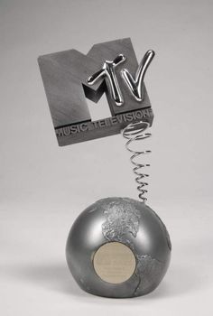 a metal object with a silver ball hanging from it's side and the word music television above it