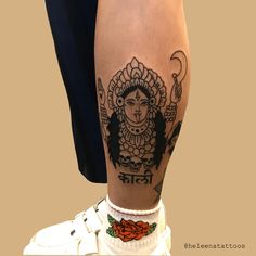 a woman's leg with tattoos on it