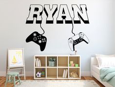 two video game controllers with the word ryan above them on a wall in a child's bedroom