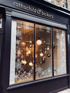 a store front with snowflakes on the windows