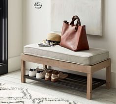 a brown purse sitting on top of a wooden bench next to a pair of shoes