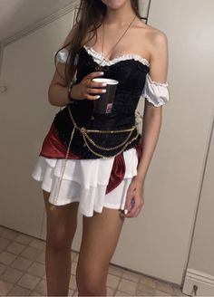 a woman in a corset is holding a cup