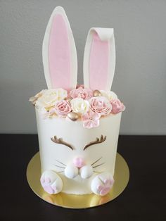 a cake decorated with flowers and bunny ears