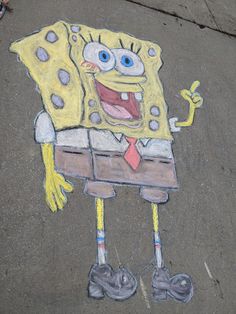 a chalk drawing of spongebob holding a wrench