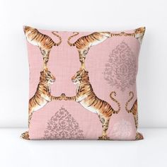 a pink pillow with two tigers on the front and one in the back, against a white background