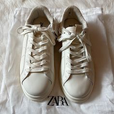 Nwt Size 39 Zara White Leather Sneakers! Original Owners. Purchased From Zara Website. Only Tried On. Never Worn. These Are Actually A Size 6 In Big Kids But I Bought Them For Myself. I Wear A Size 8 In Women’s And They Fit Me With A Little Room To Spare. I Would Say They Fit An 8-8.5 Best. (I Took A Pic With My Toes Poking Up To Show Where They Go To.) These Shoes Are Super Comfy. The Insoles Are So Think And Squishy. Neutral Gender. Includes Zara Dustbag Shown In Pics. New With Tags And In Per Casual Cream Sneakers With White Laces, Cream Sneakers With White Laces And Round Toe, Cream Sneakers With White Laces, Leather Sneakers With White Laces For Spring, Zara Casual Sneakers With Textured Sole, Zara Casual Leather Sneakers, Zara Leather Sneakers, Zara Casual Sneakers With Rubber Sole, Zara Low-top Sneakers With Contrast Sole