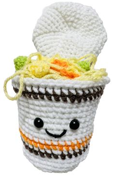 a crocheted coffee cup with a smiling face