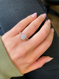 a woman's hand with a diamond ring on it