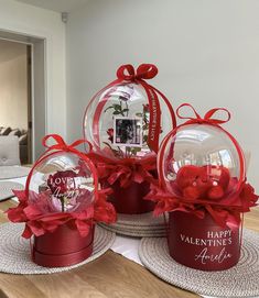 three valentine's day gifts in red boxes on a table