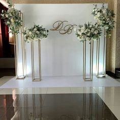 an elegant wedding ceremony setup with flowers and monogrammed decorations