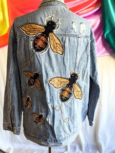 a denim jacket with embroidered bees on it