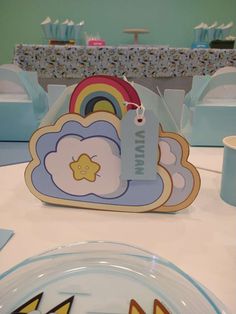 a table set up with plates, napkins and place settings for a baby's first birthday party