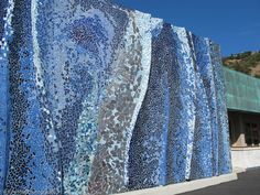 a large blue and white mosaic on the side of a building