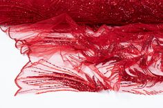 red sequin mesh fabric on white background