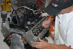 a man working on an engine in a garage