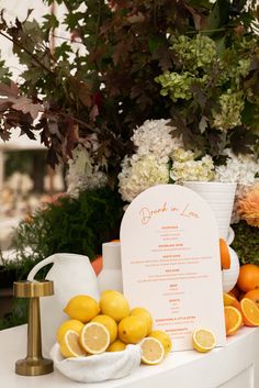 the table is set up with lemons and oranges