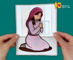 a person holding up a card with an image of a woman praying