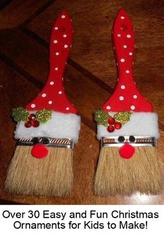 two red and white christmas decorations sitting on top of a wooden table