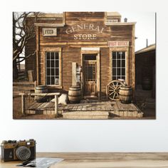 an old fashioned store front with barrels on the porch and a camera next to it