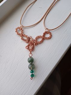 a close up of a necklace on a window sill