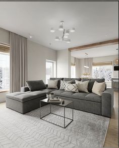 a living room with a couch, chair and coffee table in front of a large window