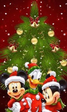 two mickey and minnie mouses in front of a christmas tree with the caption for google