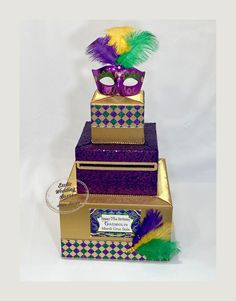 three tiered boxes with mardi gras decorations