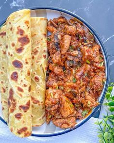 two flatbreads on a plate with meat and vegetables next to eachother