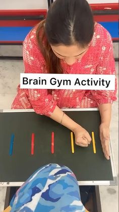 a woman sitting at a table working on a piece of art with the words brain gym activity