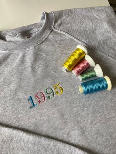 Custom Embroidered Birthday Sweatshirt, Monogram, Birthdate, Gift, Birthday Gift, Sweatshirt/T-shirt - Unisex FOLLOW THESE 5 STEPS TO ORDER: 1. Please check the listing photos for size guides, colour of garments, font options, thread colours  2. Select the colour (If you want a different colour which is not listed up, message us) 3. Select your size (S-XXL) 4. 'Add your personalisation' choosing from fonts, thread colours and placement EXAMPLE TEXT - 1996 FONT - 2 THREAD COLOUR - 27 (if you want Embroidered Crew Neck Top For Birthday, Birthday Embroidered Text T-shirt With Crew Neck, Birthday Crew Neck T-shirt With Embroidered Text, Embroidered Crew Neck Birthday T-shirt, Embroidered Crew Neck T-shirt For Birthday, Custom Embroidery Crew Neck Top For Birthday, Custom Embroidered Crew Neck Top For Birthday, Birthday Sweatshirt, Diy Embroidery Designs