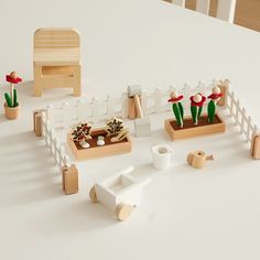 a table topped with wooden toys and plants