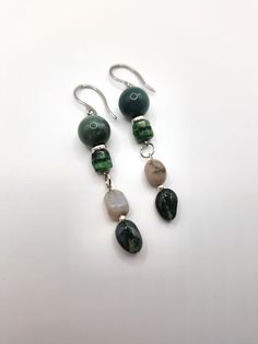 Earthy forest-inspired gemstone earrings; crafted with Indian agate stone pebbles, polished deep green agate stone, and mossy colored Czech glass beading. *Handmade by me, one of a kind. *Length: 7.2 cm *Diameter of green agate: 12 mm *Crafted with silver stainless steel hypoallergenic hooks.  Nickel free. Click on the link below if you would like to see more artisan jewelry and unique artwork! https://www.etsy.com/shop/CailinCreatesCo I try my best to accurately portray the details in all of my jewelry. Please note that colors may vary due to lighting conditions, camera settings, and variations in computer monitor or phone display settings. If you have any questions regarding any items I have available, please do not be afraid to reach out! Handmade Spiritual Jade Earrings, Natural Stone Jade Dangle Earrings, Spiritual Agate Gemstone Earrings, Spiritual Handmade Agate Earrings, Spiritual Agate Earrings With Natural Stones, Bohemian Green Earrings With Natural Stones, Bohemian Sterling Silver Earrings With Natural Stones, Handmade Green Agate Earrings, Earthy Drop Earrings With Natural Stones