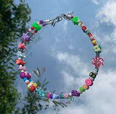 a colorful necklace is hanging from a tree