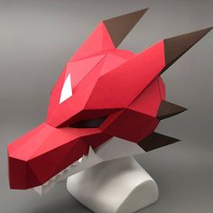 a paper sculpture of a red dragon's head