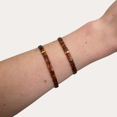 The Katherine Bracelet is made of transparent brown and 24kt gold plated glass beads! Each bracelet has a tarnish resistant gold plated stainless steel logo bead and two 14k gold filled beads. It also is made with elastic to easily slip over your hand to your wrist. Nickel free. Two sizes- Petite: approximately 6" round Regular: approximately 7" round Need help picking a size? Get a piece of string and wrap it around the part of your wrist you like. If between both sizes, I recommend sizing up. Brown Stretch Bracelet With Letter Beads As Gift, Steel Logo, Wedding Jewelry Bracelets, 24kt Gold, Olive Branch, Wedding Bracelet, Everyday Jewelry, Bridal Party, Wedding Jewelry