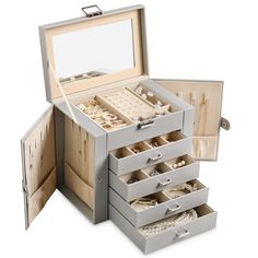 an open jewelry box with five drawers