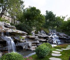 there is a waterfall in the middle of this garden