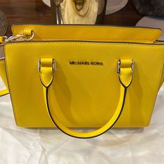 No Longer Has Tags But Still In Original Wrappers & Dust Bag. Beautiful Yellow Color! Measurements Shown In Photos. Yellow Rectangular Bag With Branded Hardware, Yellow Rectangular Bags With Branded Hardware, Yellow Travel Bag With Branded Hardware, Yellow Leather Shoulder Bag With Branded Hardware, Yellow Shoulder Bag With Branded Hardware For Travel, Classic Yellow Shoulder Bag With Handles, Classic Yellow Top Handle Bag, Classic Yellow Shoulder Bag, Elegant Yellow Bag With Branded Hardware