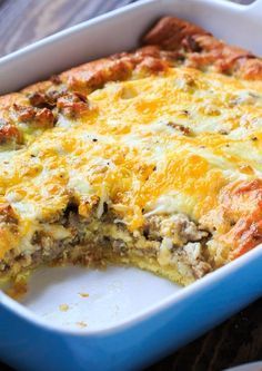 a casserole with meat and cheese in a blue dish on a wooden table